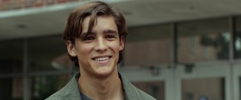 Movie still from “Oculus” (2013), directed by Mike Flanagan – A young man smiling for the camera; Close Up shot, Over the shoulder angle