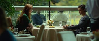 Movie still from “Oculus” (2013), directed by Mike Flanagan – A woman sitting at a table in front of a glass of wine; Medium shot, Over the shoulder angle