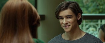 Movie still from “Oculus” (2013), directed by Mike Flanagan – A young man smiling at the camera in front of a mirror; Close Up shot, Over the shoulder angle