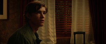 Movie still from “Oculus” (2013), directed by Mike Flanagan – A young man is looking into the distance; Close Up shot, Low angle