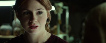 Movie still from “Oculus” (2013), directed by Mike Flanagan – A woman's face in front of a mirror; Close Up shot, Over the shoulder angle