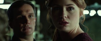 Movie still from “Oculus” (2013), directed by Mike Flanagan – A man and a woman looking at the camera; Close Up shot, Low angle