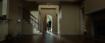 Movie still from “Oculus” (2013), directed by Mike Flanagan – Two people are standing in a doorway of a house; Wide shot, Low angle