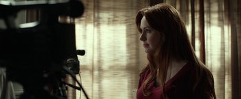 Movie still from “Oculus” (2013), directed by Mike Flanagan – A beautiful young woman standing in front of a video camera; Close Up shot, Over the shoulder angle