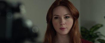Movie still from “Oculus” (2013), directed by Mike Flanagan – A person with long red hair; Close Up shot, Over the shoulder angle