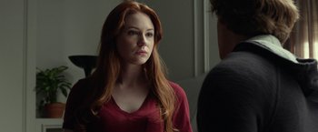 Movie still from “Oculus” (2013), directed by Mike Flanagan – A beautiful young woman standing in front of a mirror; Close Up shot, Over the shoulder angle