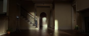 Movie still from “Oculus” (2013), directed by Mike Flanagan – A young boy standing at the bottom of a staircase; Extreme Wide shot, Low angle