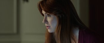 Movie still from “Oculus” (2013), directed by Mike Flanagan – A person with long red hair; Close Up shot, Over the shoulder angle