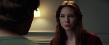 Movie still from “Oculus” (2013), directed by Mike Flanagan – A woman with long red hair is looking at the camera; Close Up shot, Over the shoulder angle