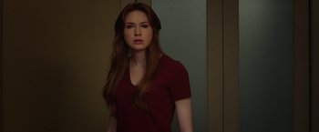 Movie still from “Oculus” (2013), directed by Mike Flanagan – A beautiful young lady wearing a red shirt; Medium shot, Over the shoulder angle