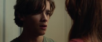 Movie still from “Oculus” (2013), directed by Mike Flanagan – A young man looking at a woman in a room; Close Up shot, Over the shoulder angle