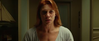 Movie still from “Oculus” (2013), directed by Mike Flanagan – A person with long red hair; Close Up shot, Low angle