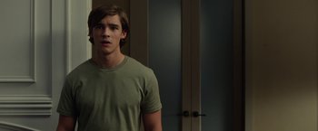Movie still from “Oculus” (2013), directed by Mike Flanagan – A man standing in front of a door in a room; Medium shot, Over the shoulder angle