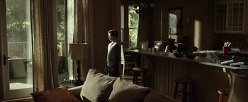 Movie still from “Oculus” (2013), directed by Mike Flanagan – A young boy standing in front of a television in a living room; Wide shot, Over the shoulder angle