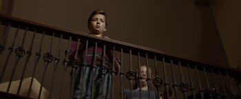 Movie still from “Oculus” (2013), directed by Mike Flanagan – A boy and a girl standing at the top of a railing; Medium shot, Low angle