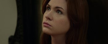 Movie still from “Oculus” (2013), directed by Mike Flanagan – A person with long red hair; Close Up shot, Low angle