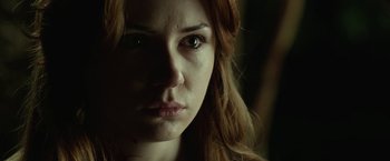 Movie still from “Oculus” (2013), directed by Mike Flanagan – A woman's face in the dark; Close Up shot, Low angle