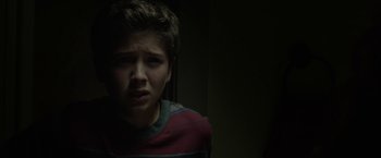 Movie still from “Oculus” (2013), directed by Mike Flanagan – A young boy is looking at the camera; Close Up shot, Low angle