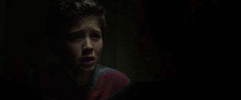 Movie still from “Oculus” (2013), directed by Mike Flanagan – A young boy is looking at the camera; Close Up shot, Over the shoulder angle