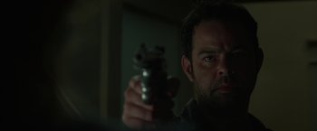 Movie still from “Oculus” (2013), directed by Mike Flanagan – A person holding a gun in his hand; Close Up shot, Over the shoulder angle