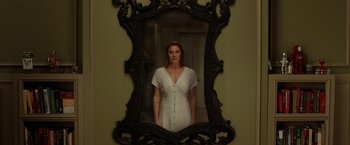 Movie still from “Oculus” (2013), directed by Mike Flanagan – A woman standing in front of an ornate mirror; Medium shot, Low angle