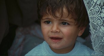 Movie still from “Oedipus Rex” (1967), directed by Pier Paolo Pasolini – A child's face looking at the camera; Close Up shot, High angle
