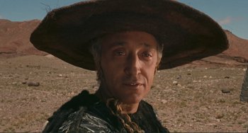 Movie still from “Oedipus Rex” (1967), directed by Pier Paolo Pasolini – A person wearing a hat; Close Up shot, Low angle