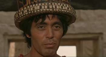 Movie still from “Oedipus Rex” (1967), directed by Pier Paolo Pasolini – A person wearing a hat; Close Up shot, Low angle
