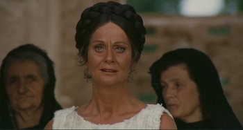 Movie still from “Oedipus Rex” (1967), directed by Pier Paolo Pasolini – An old woman with blue eyes wearing a white dress; Close Up shot, Over the shoulder angle