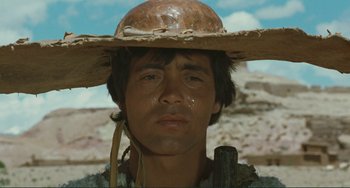 Movie still from “Oedipus Rex” (1967), directed by Pier Paolo Pasolini – A man with a hat on his head; Close Up shot, Low angle