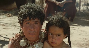 Movie still from “Oedipus Rex” (1967), directed by Pier Paolo Pasolini – Two young boys are posing for a picture; Close Up shot, Over the shoulder angle