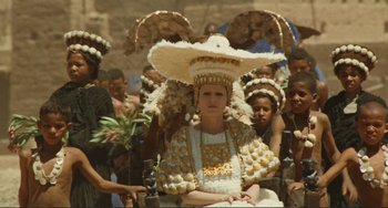 Movie still from “Oedipus Rex” (1967), directed by Pier Paolo Pasolini – A woman wearing a hat with feathers on her head; Medium shot, High angle