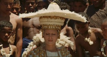 Movie still from “Oedipus Rex” (1967), directed by Pier Paolo Pasolini – A woman wearing a hat with feathers on her head; Close Up shot, High angle
