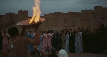 Movie still from “Oedipus Rex” (1967), directed by Pier Paolo Pasolini – A group of people standing in front of a crowd; Extreme Wide shot, Over the shoulder angle