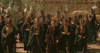 Movie still from “Oedipus Rex” (1967), directed by Pier Paolo Pasolini – A group of people standing next to each other; Wide shot, High angle