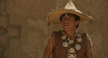 Movie still from “Oedipus Rex” (1967), directed by Pier Paolo Pasolini – A man wearing a straw hat and a necklace; Close Up shot, Low angle