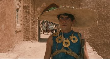 Movie still from “Oedipus Rex” (1967), directed by Pier Paolo Pasolini – A man wearing a straw hat and a blue shirt; Close Up shot, Low angle