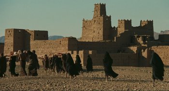 Movie still from “Oedipus Rex” (1967), directed by Pier Paolo Pasolini – A group of people walking on a dirt ground; Extreme Wide shot, Low angle