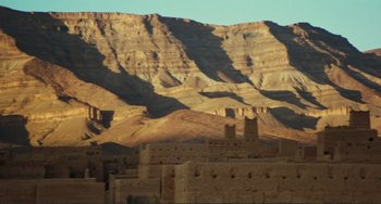 Movie still from “Oedipus Rex” (1967), directed by Pier Paolo Pasolini – A view of a mountain range with a castle in the foreground; Extreme Wide shot, Low angle