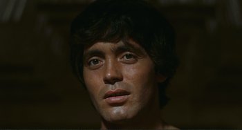 Movie still from “Oedipus Rex” (1967), directed by Pier Paolo Pasolini – A man's face in a dark room; Close Up shot, Low angle
