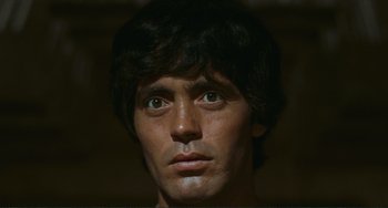 Movie still from “Oedipus Rex” (1967), directed by Pier Paolo Pasolini – A man's face in the dark; Close Up shot, Low angle