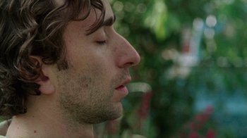 Movie still from “Old Joy” (2006), directed by Kelly Reichardt – A man's face with his eyes closed; Close Up shot, Over the shoulder angle