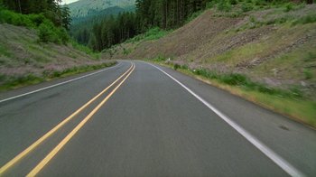 Movie still from “Old Joy” (2006), directed by Kelly Reichardt – A view of a road from a car window; Extreme Wide shot, High angle