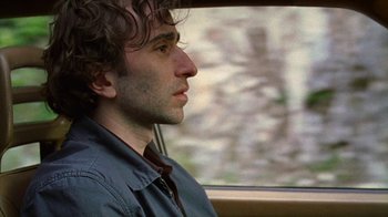 Movie still from “Old Joy” (2006), directed by Kelly Reichardt – A man sitting in a car looking out the window; Close Up shot, Over the shoulder angle