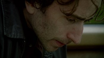 Movie still from “Old Joy” (2006), directed by Kelly Reichardt – A man's face as he looks down; Extreme Close Up shot, Low angle