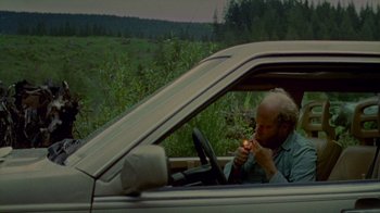 Movie still from “Old Joy” (2006), directed by Kelly Reichardt – A man sitting in the driver's seat of a car; Medium shot, High angle