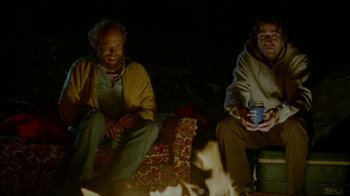 Movie still from “Old Joy” (2006), directed by Kelly Reichardt – A couple of men sitting next to each other in front of a fire; Medium shot, Over the shoulder angle