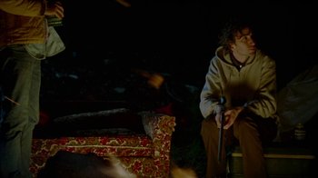 Movie still from “Old Joy” (2006), directed by Kelly Reichardt – A man sitting on a chair in the dark; Medium shot, High angle