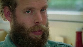 Movie still from “Old Joy” (2006), directed by Kelly Reichardt – A person with a beard; Close Up shot, Low angle