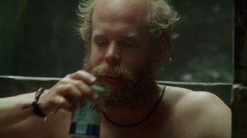 Movie still from “Old Joy” (2006), directed by Kelly Reichardt – A man with a long beard is holding a bottle of water; Close Up shot, Low angle